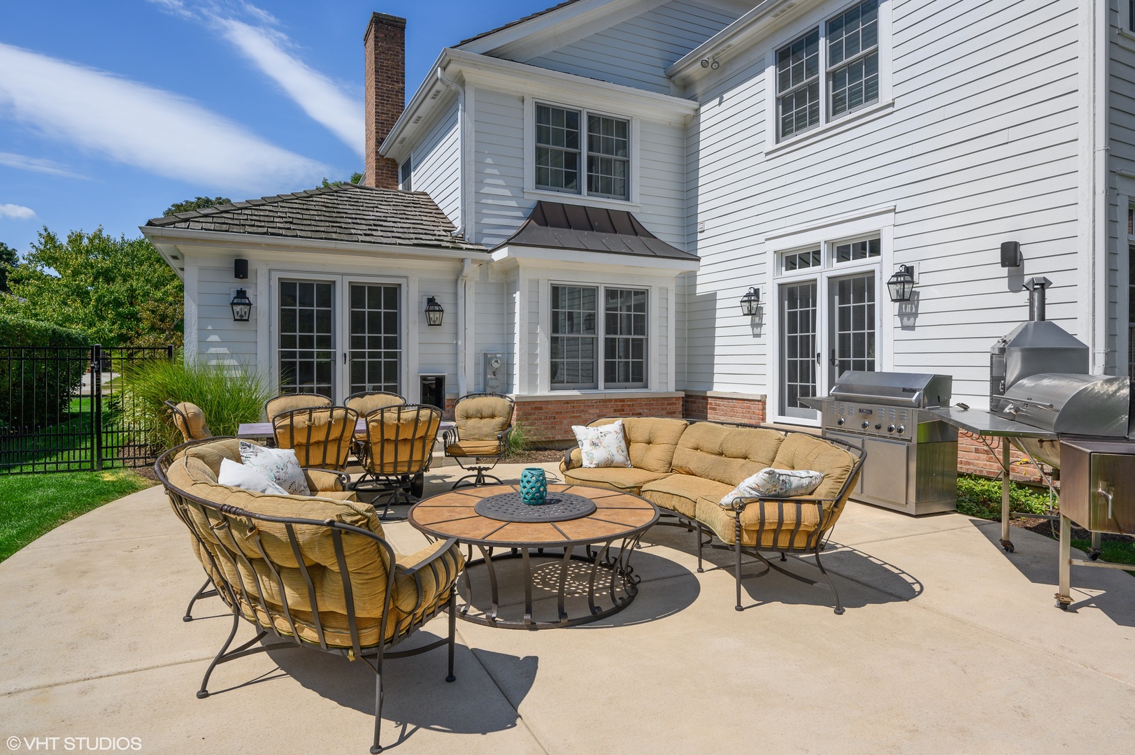 909 Windsor Road Glenview, IL 60025 - Photo 40 of 47 a view of a patio with couches table and chairs potted plants and palm trees