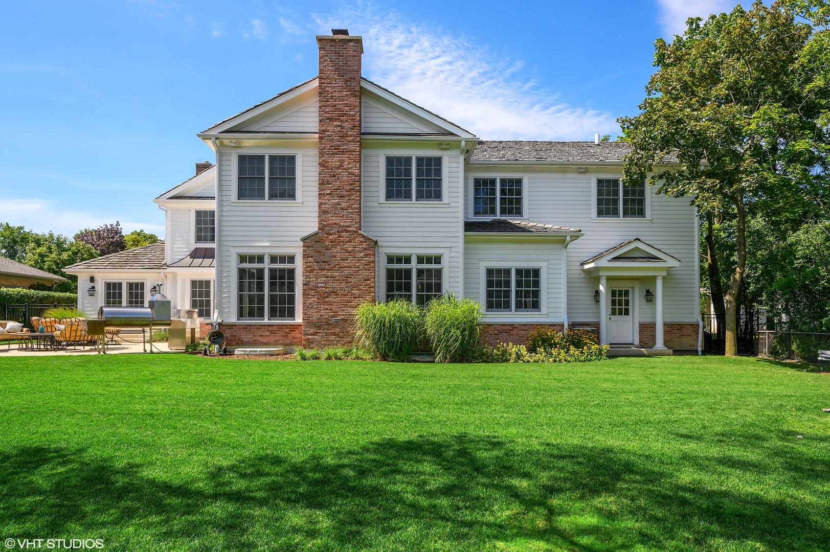 909 Windsor Road Glenview, IL 60025 - Photo 42 of 47 a front view of a house with a garden and trees