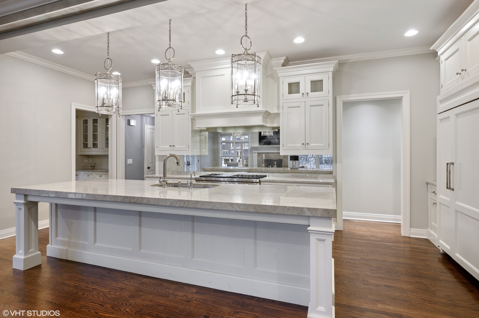 909 Windsor Road Glenview, IL 60025 - Photo 10 of 47 a kitchen with kitchen island white cabinets and refrigerator