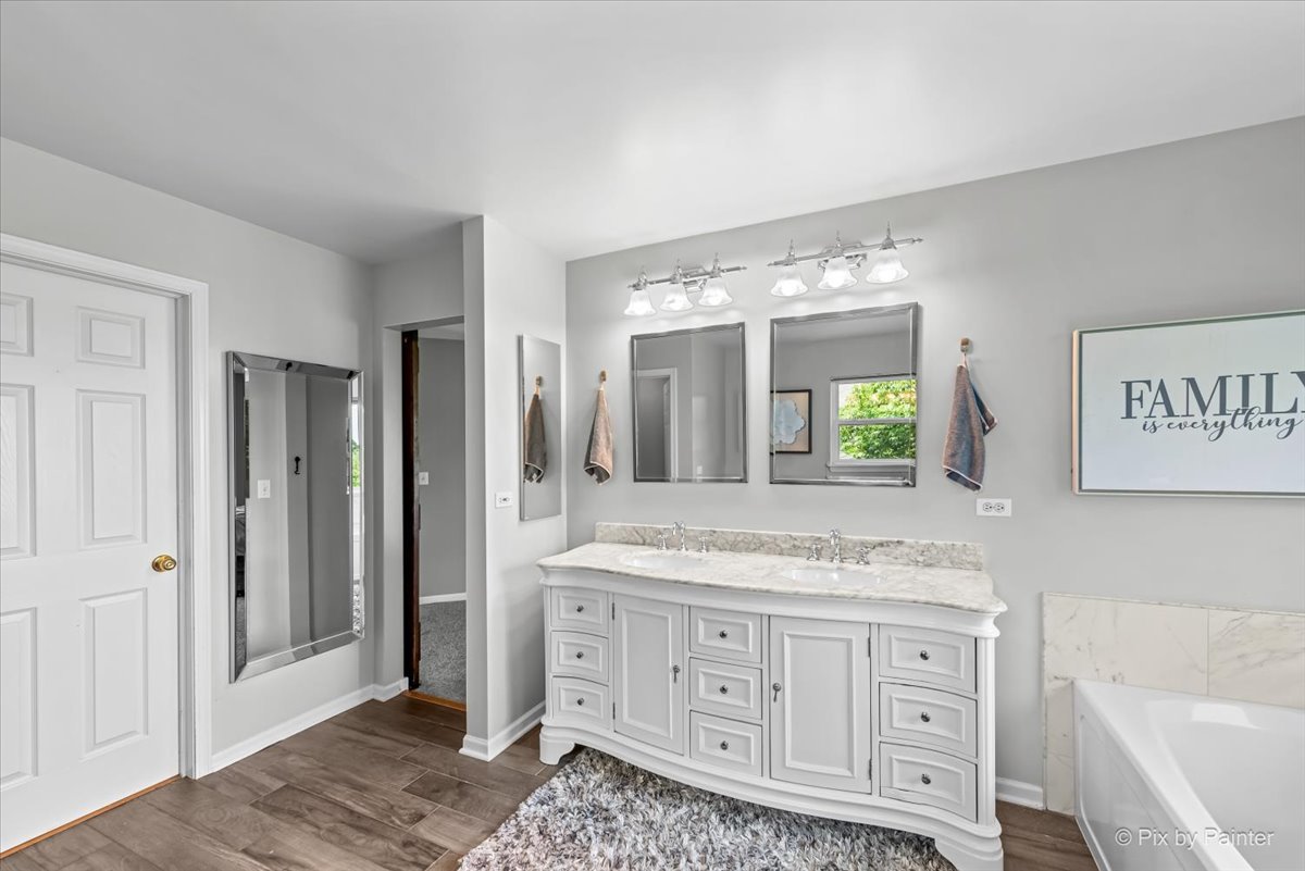237 Foxford Drive Cary, IL 60013 - Photo 34 of 66 a bathroom with a granite countertop sink mirror and bathtub