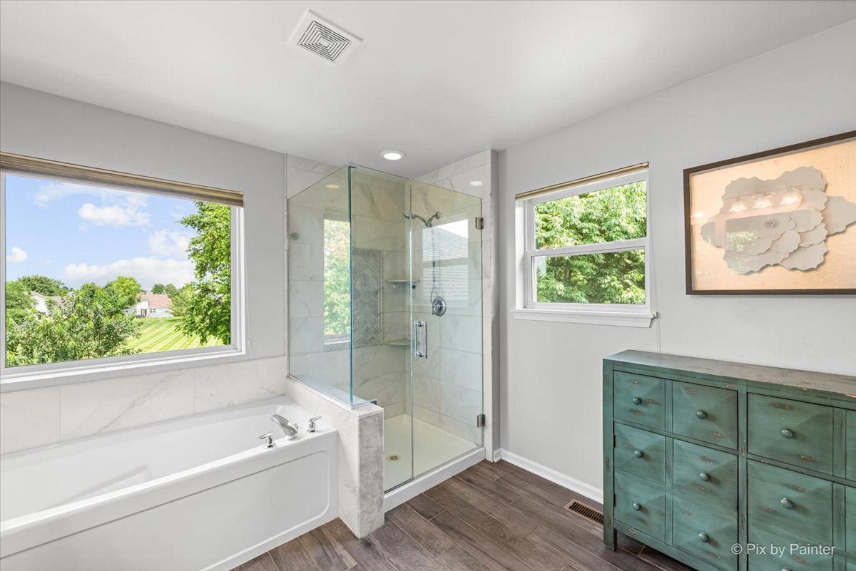 237 Foxford Drive Cary, IL 60013 - Photo 35 of 66 a bathroom with a tub a sink and a window