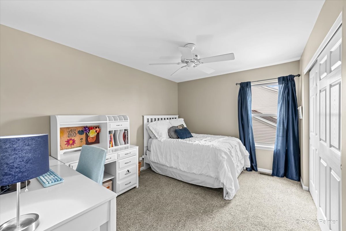 237 Foxford Drive Cary, IL 60013 - Photo 40 of 66 a bed room with a bed and a chandelier