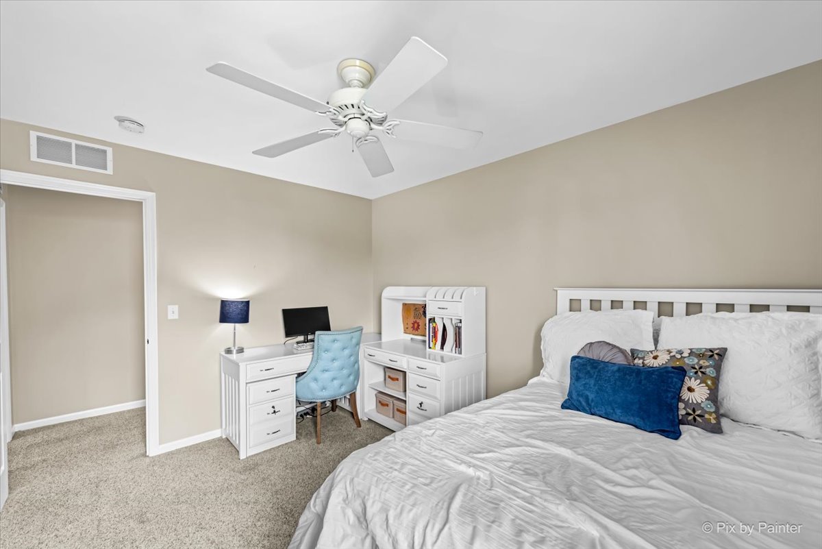 237 Foxford Drive Cary, IL 60013 - Photo 41 of 66 a bedroom with a bed and a chandelier
