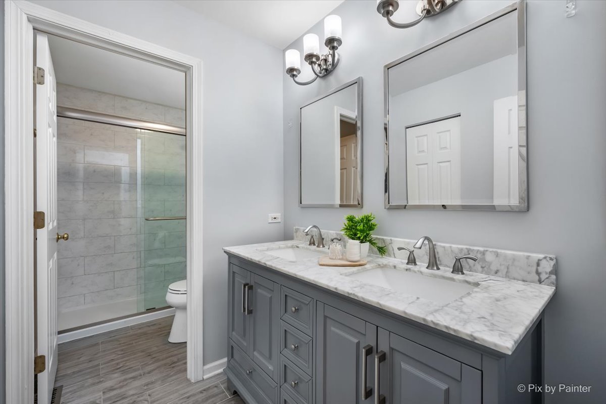 237 Foxford Drive Cary, IL 60013 - Photo 42 of 66 a bathroom with a granite countertop sink a toilet and shower