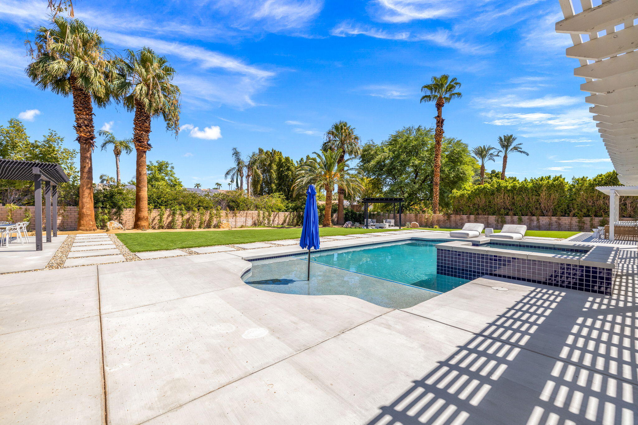 72278 Barbara Drive Rancho Mirage, CA 92270 - Photo 17 of 69 a park view with a bench and palm trees