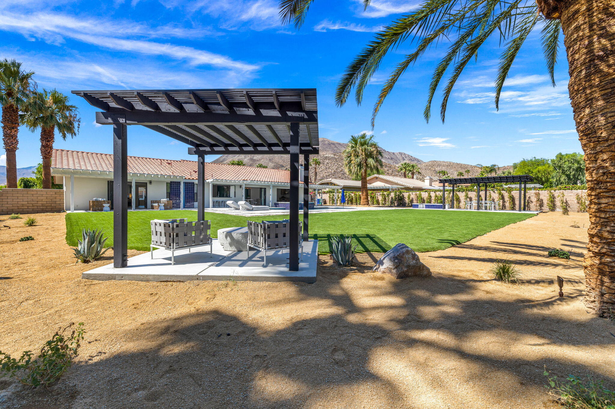 72278 Barbara Drive Rancho Mirage, CA 92270 - Photo 26 of 69 a view of a swimming pool with a patio and a garden