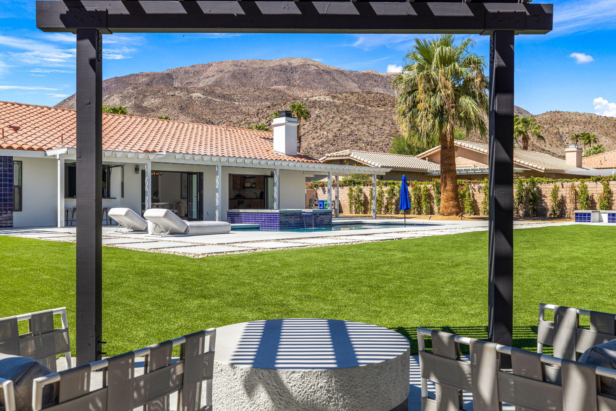 72278 Barbara Drive Rancho Mirage, CA 92270 - Photo 27 of 69 a view of a patio with table and chairs potted plants and palm tree