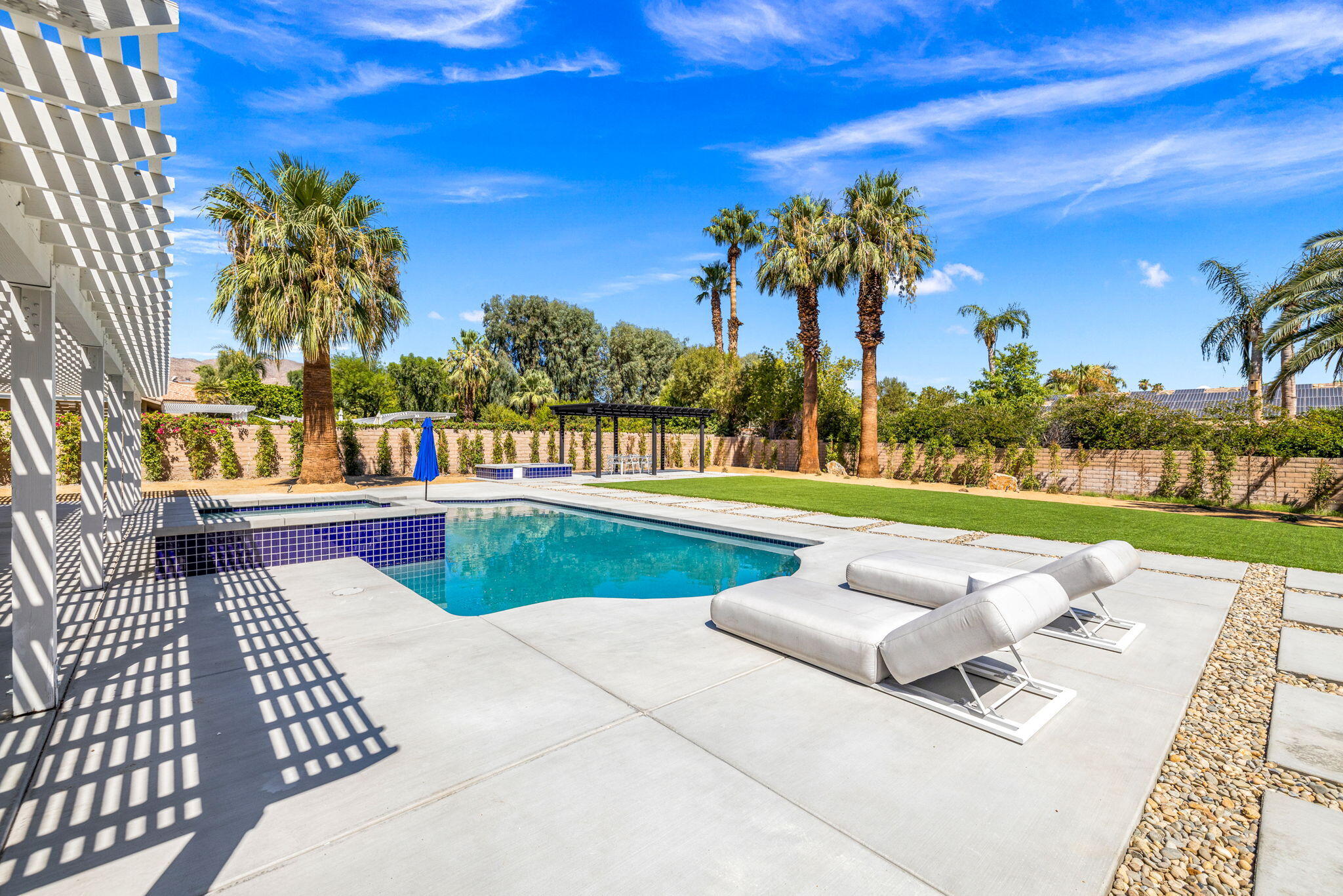 72278 Barbara Drive Rancho Mirage, CA 92270 - Photo 32 of 69 a view of swimming pool with seating space and trees in the background