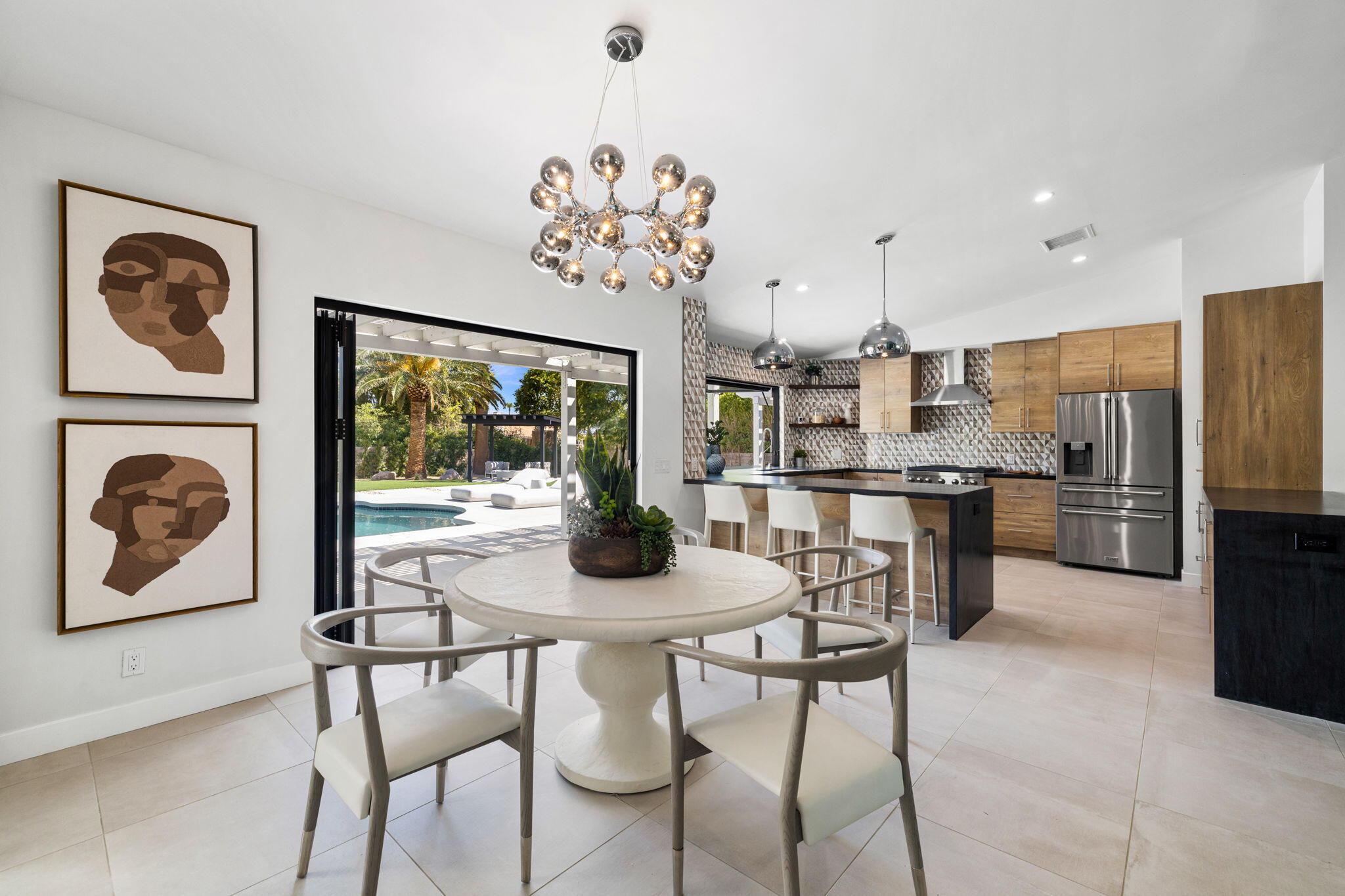 72278 Barbara Drive Rancho Mirage, CA 92270 - Photo 44 of 69 a view of a dining room with furniture a kitchen and a chandelier