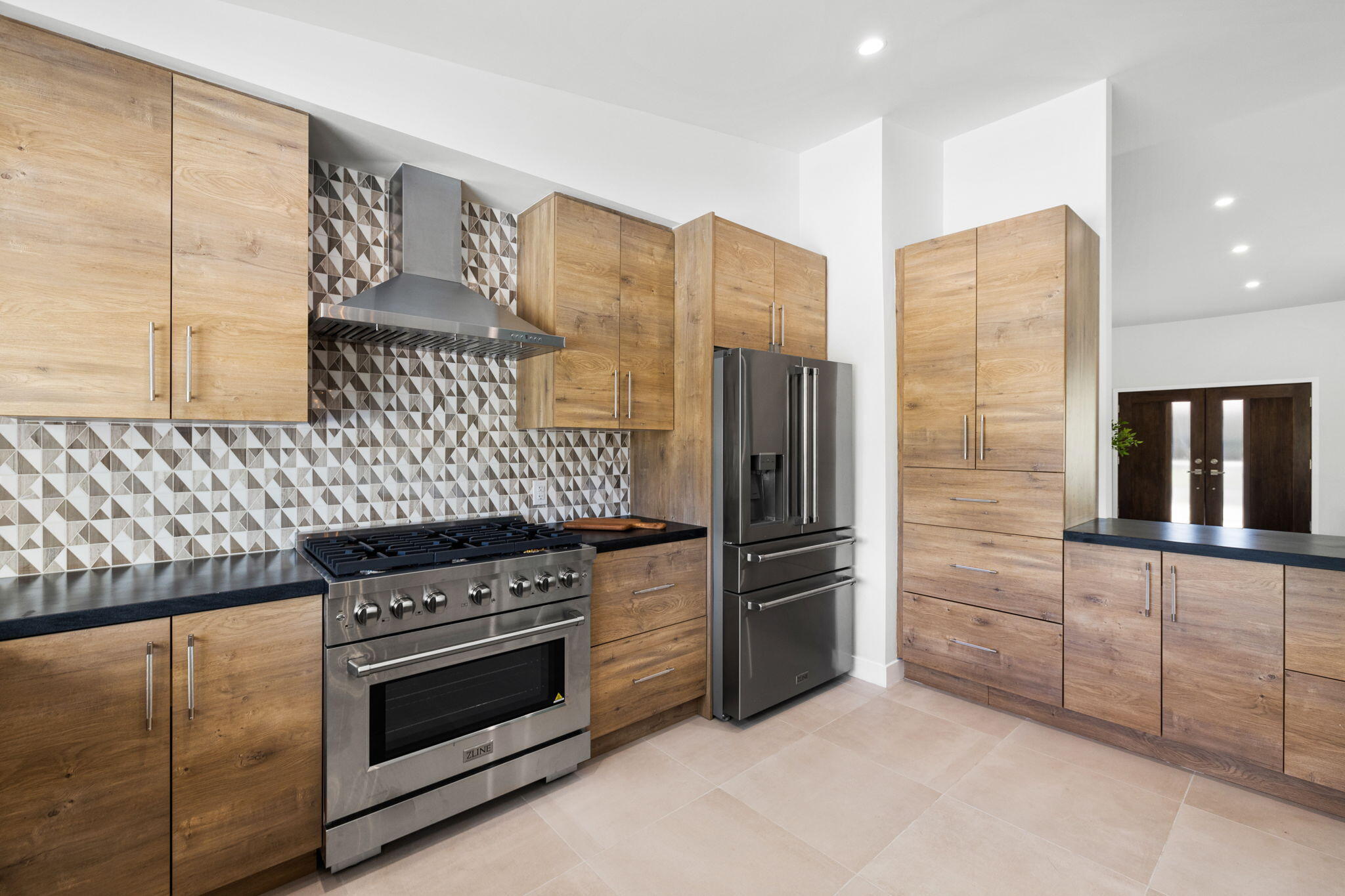 72278 Barbara Drive Rancho Mirage, CA 92270 - Photo 45 of 69 a kitchen with stainless steel appliances wooden cabinets and a stove top oven