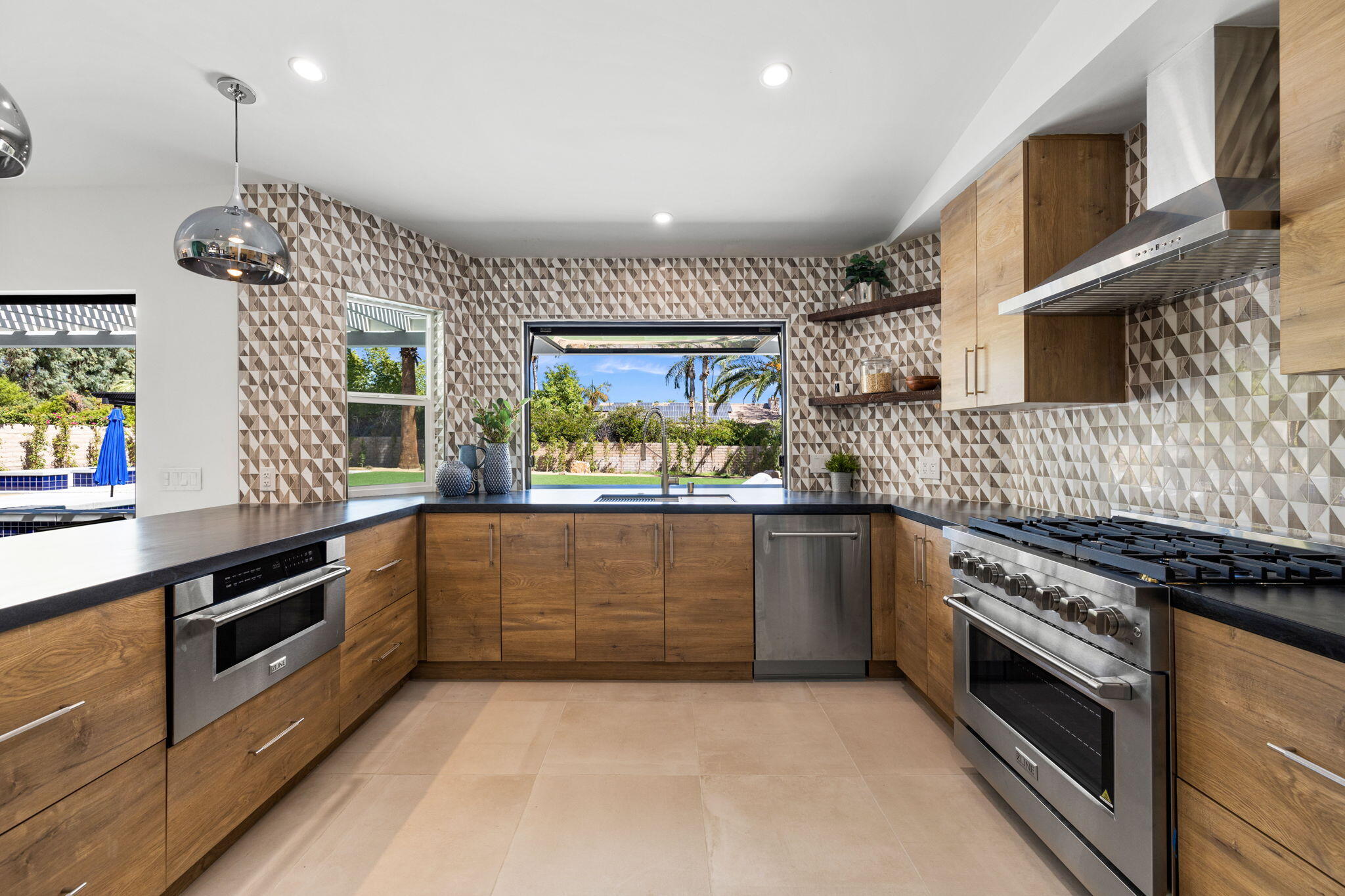 72278 Barbara Drive Rancho Mirage, CA 92270 - Photo 49 of 69 a kitchen with stainless steel appliances granite countertop a stove and a sink
