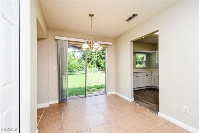 a view of an empty room with a birdcage and a window
