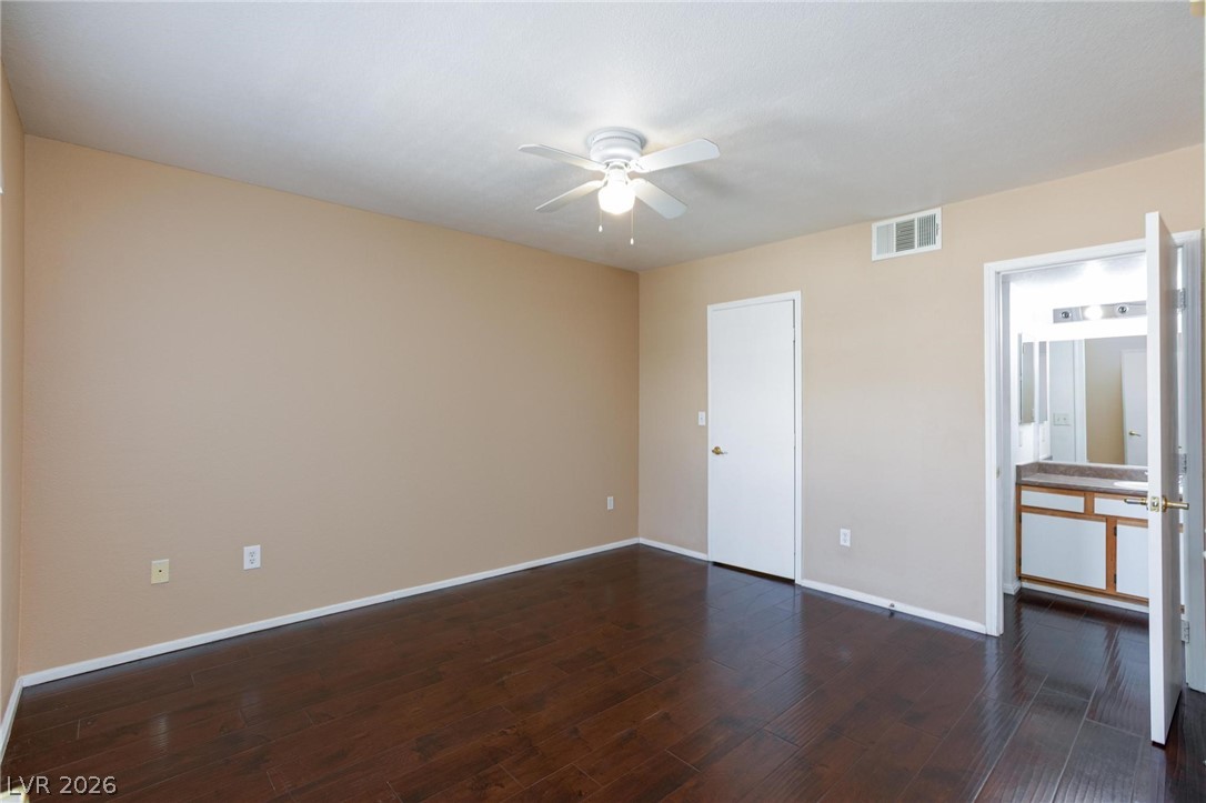 6650 West Warm Springs Road, Unit 2027 Las Vegas, NV 89118 - Photo 20 of 29 This spacious bedroom features rich hardwood flooring and convenient access to an adjacent bath.