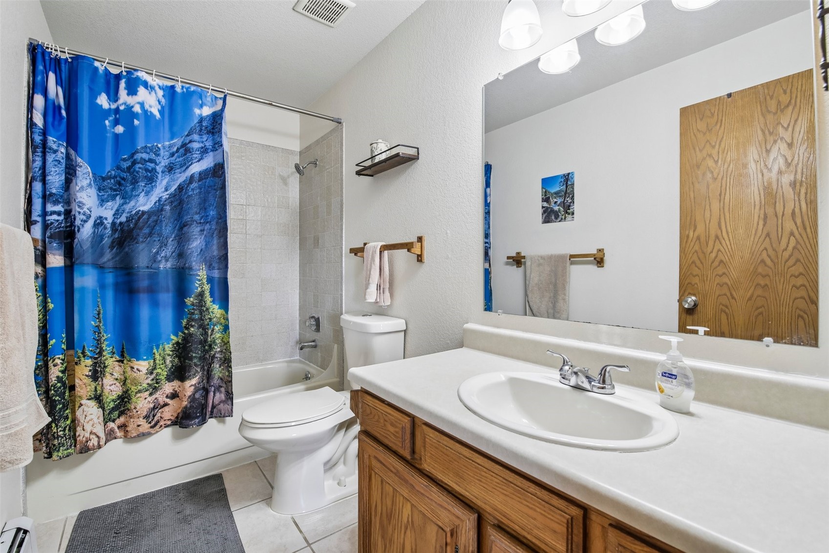 89310 Ryan Gulch Road, Unit 103 Silverthorne, CO 80498 - Photo 17 of 48 a bathroom with a sink vanity mirror and toilet