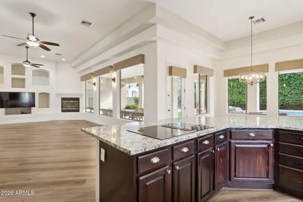 a kitchen with granite countertop a sink and a wooden floor