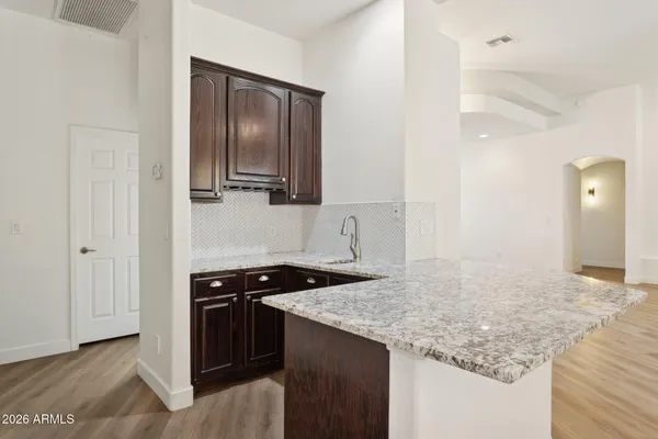 a kitchen with granite countertop cabinets and stainless steel appliances