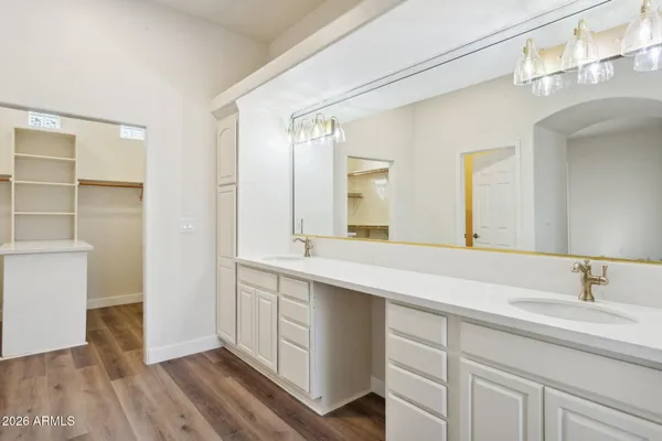 a bathroom with a double vanity sink and a mirror