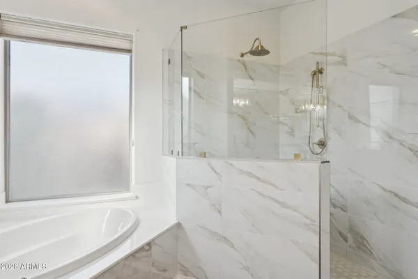 a bathroom with a bathtub and shower