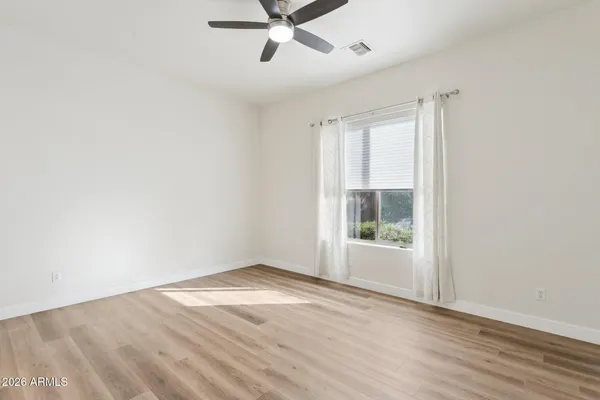 a en suite bathroom with a granite countertop sink and a mirror