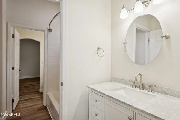 a bathroom with a sink a mirror and a shower