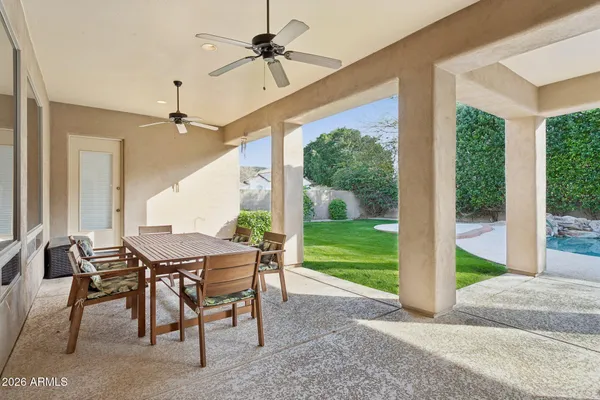 a view of a house with swimming pool and sitting area