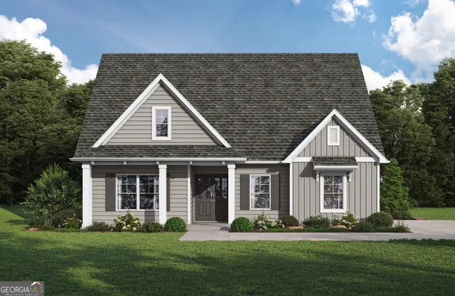 a front view of a house with a garden and plants