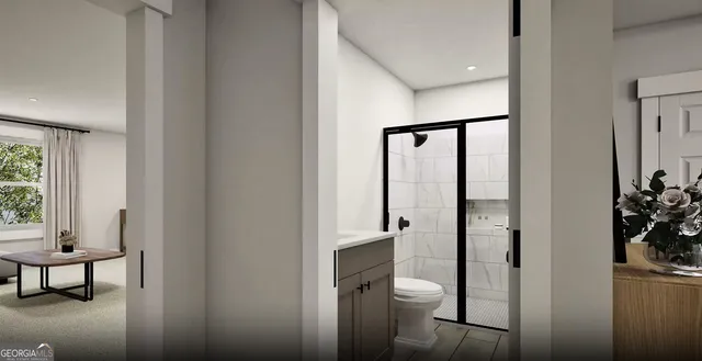 a bathroom with a glass door shower and a toilet