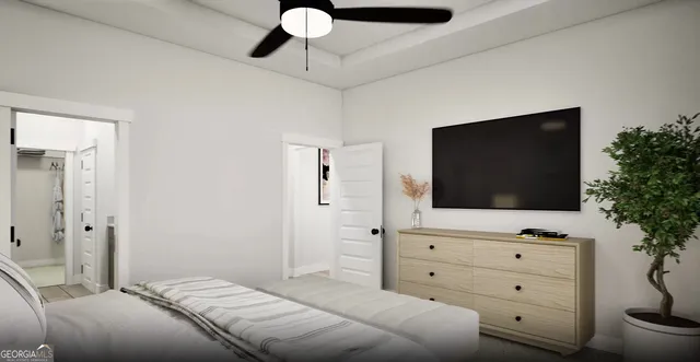 a bedroom with a bed and a flat screen tv