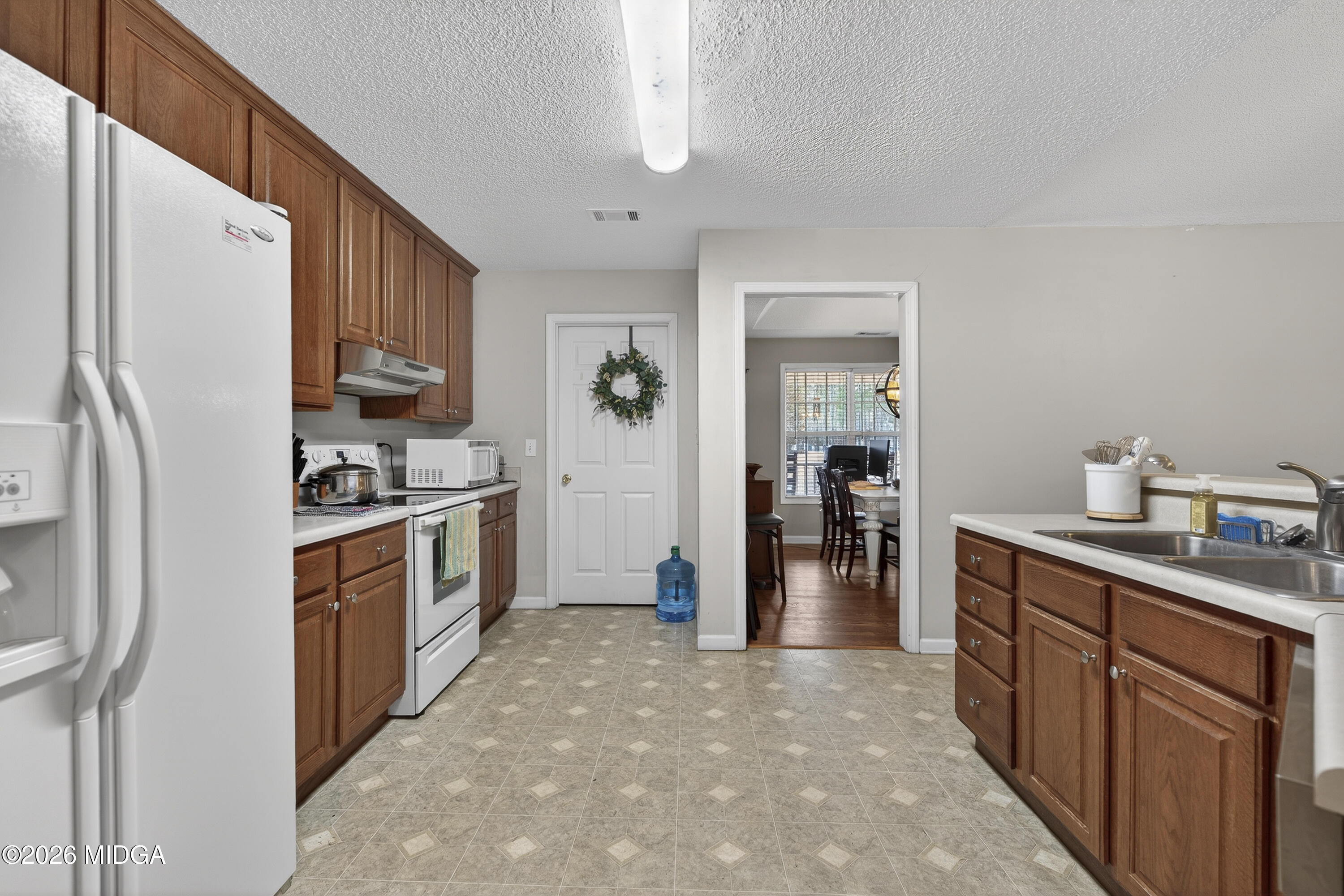 249 Southern Walk Circle Gray, GA 31032 - Photo 25 of 58 a kitchen with stainless steel appliances a refrigerator and a sink