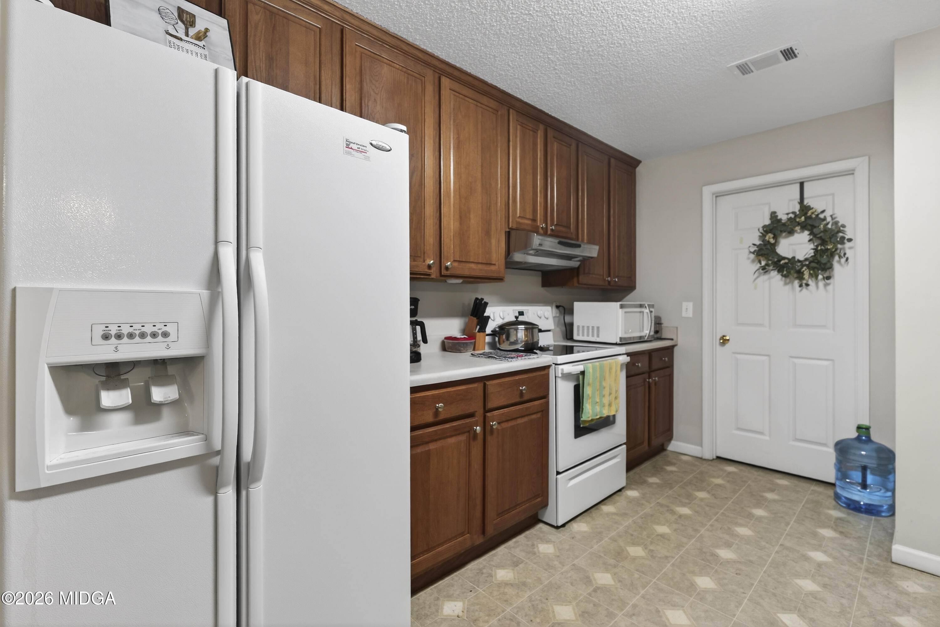 249 Southern Walk Circle Gray, GA 31032 - Photo 26 of 58 a kitchen with stainless steel appliances white cabinets and a refrigerator