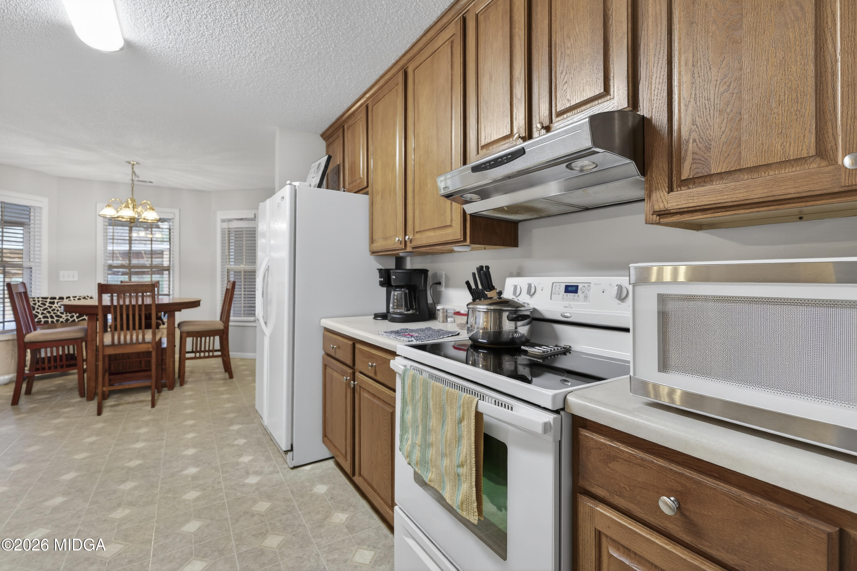 249 Southern Walk Circle Gray, GA 31032 - Photo 27 of 58 a kitchen with stainless steel appliances granite countertop a sink a stove and a refrigerator