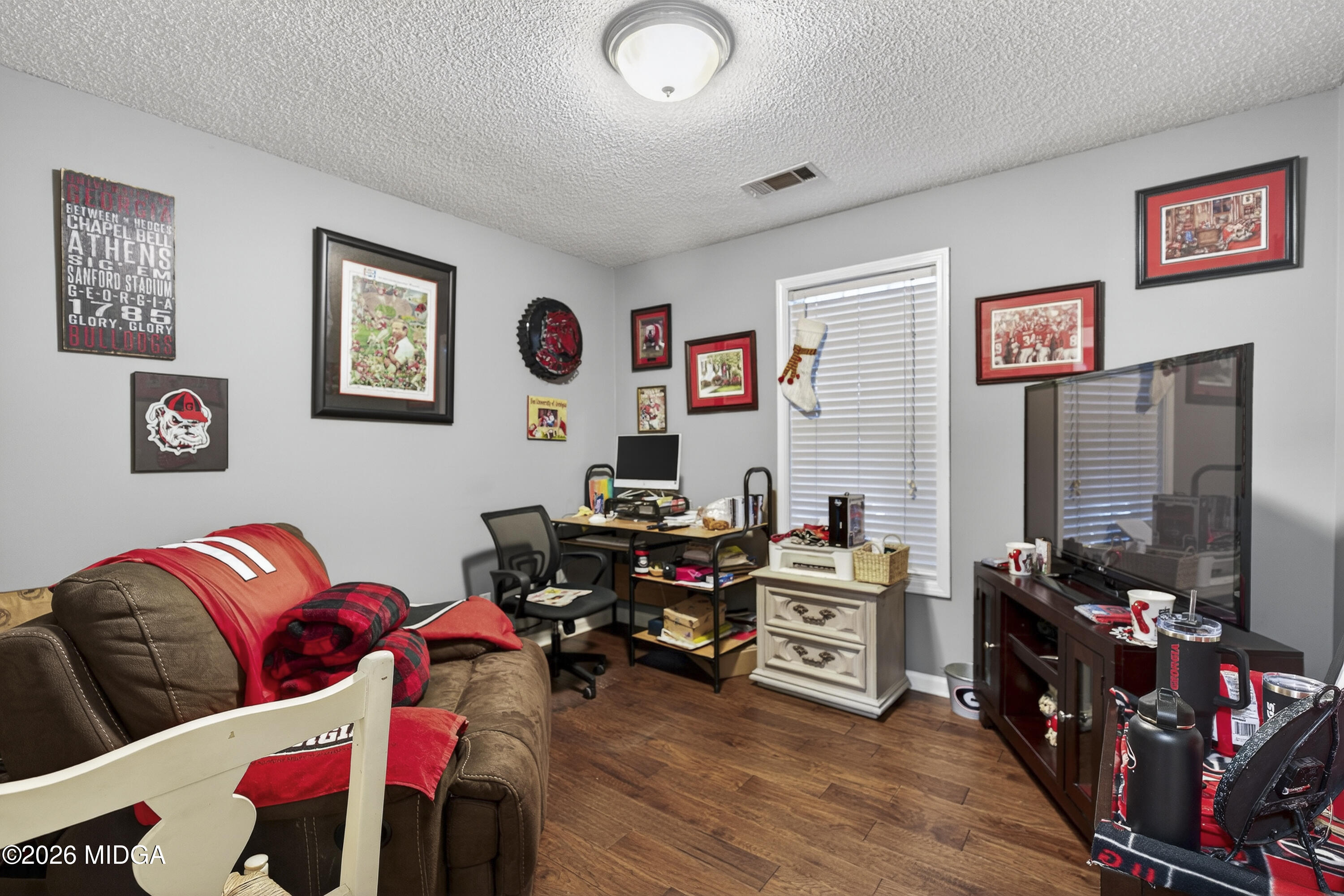 249 Southern Walk Circle Gray, GA 31032 - Photo 32 of 58 a living room with furniture and a flat screen tv