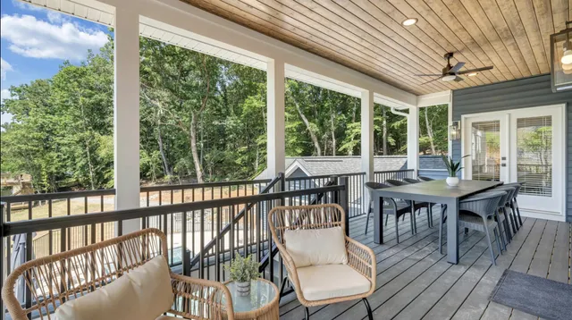 a living room with furniture a wooden floor and a chandelier