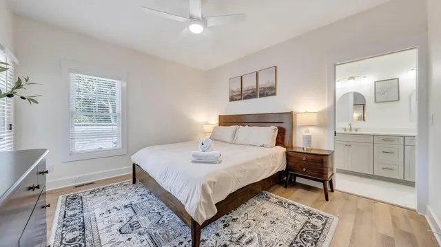 a bathroom with a double vanity sink mirror and toilet