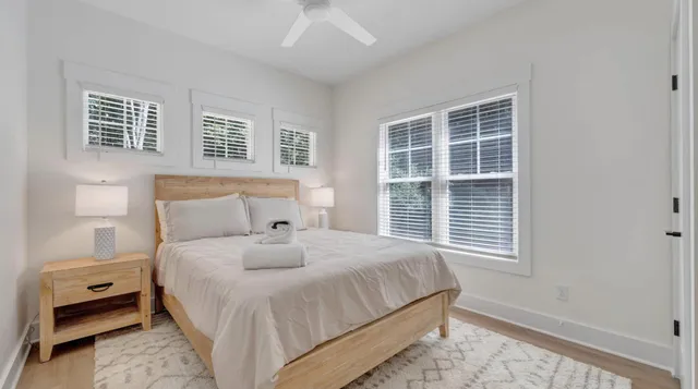 a bathroom with a sink a toilet a mirror and shower