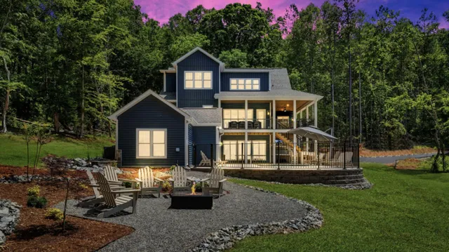 a front view of a house with a yard table and chairs