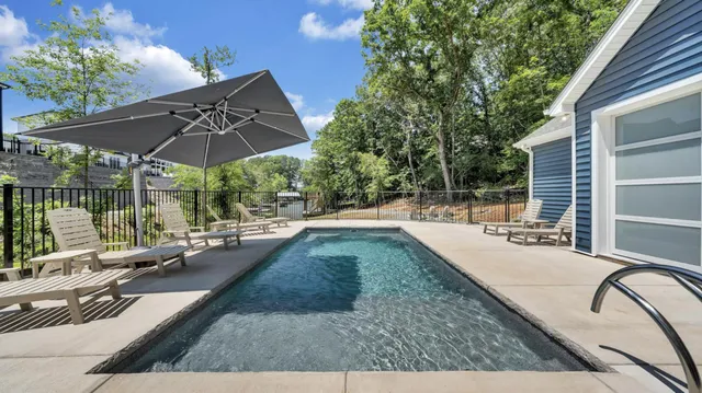 a view of a swimming pool with sitting area