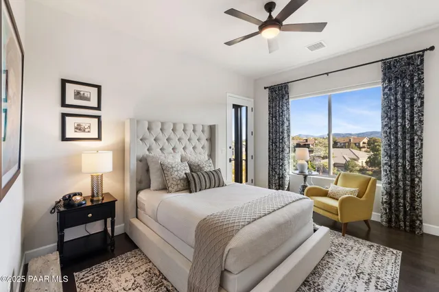 an aerial view of residential houses with outdoor space and trees