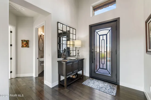 a view of an entryway with wooden floor and a livingroom