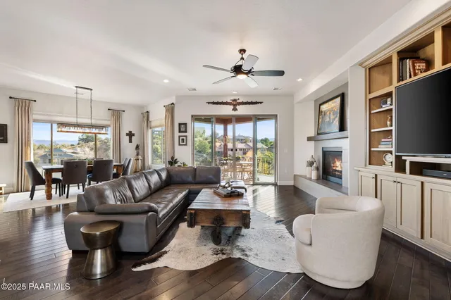 a living room with fireplace furniture and a flat screen tv
