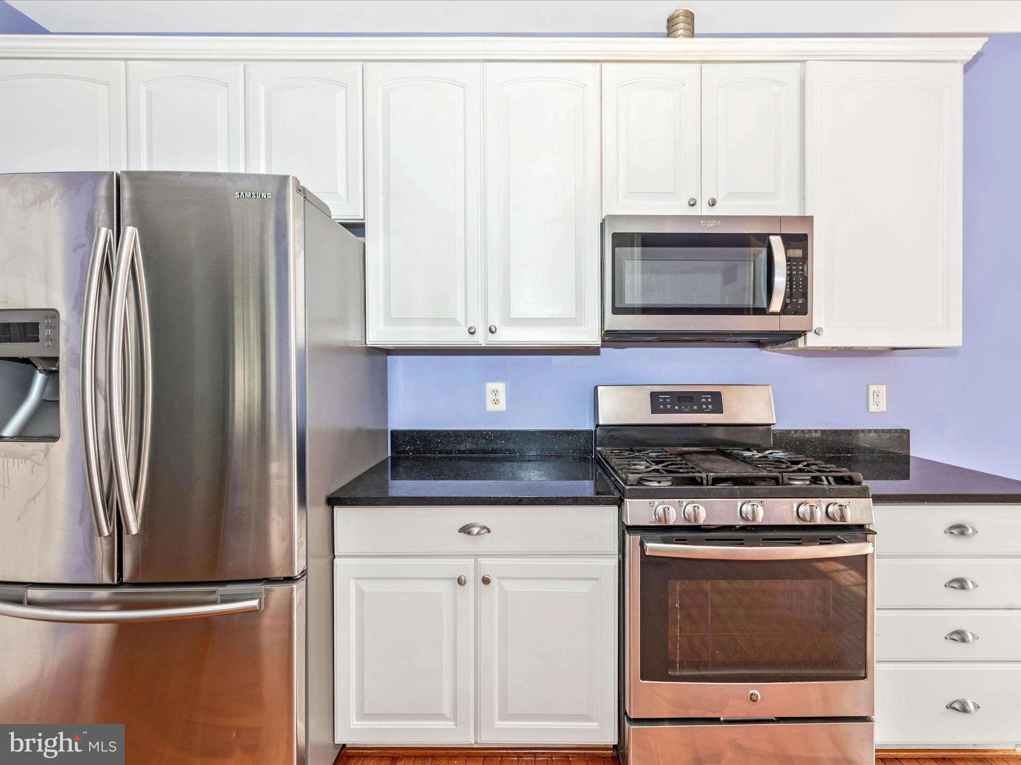 10811 Wadsworth Road Woodstock, MD 21163 - Photo 14 of 66 a kitchen with granite countertop a refrigerator stove and microwave