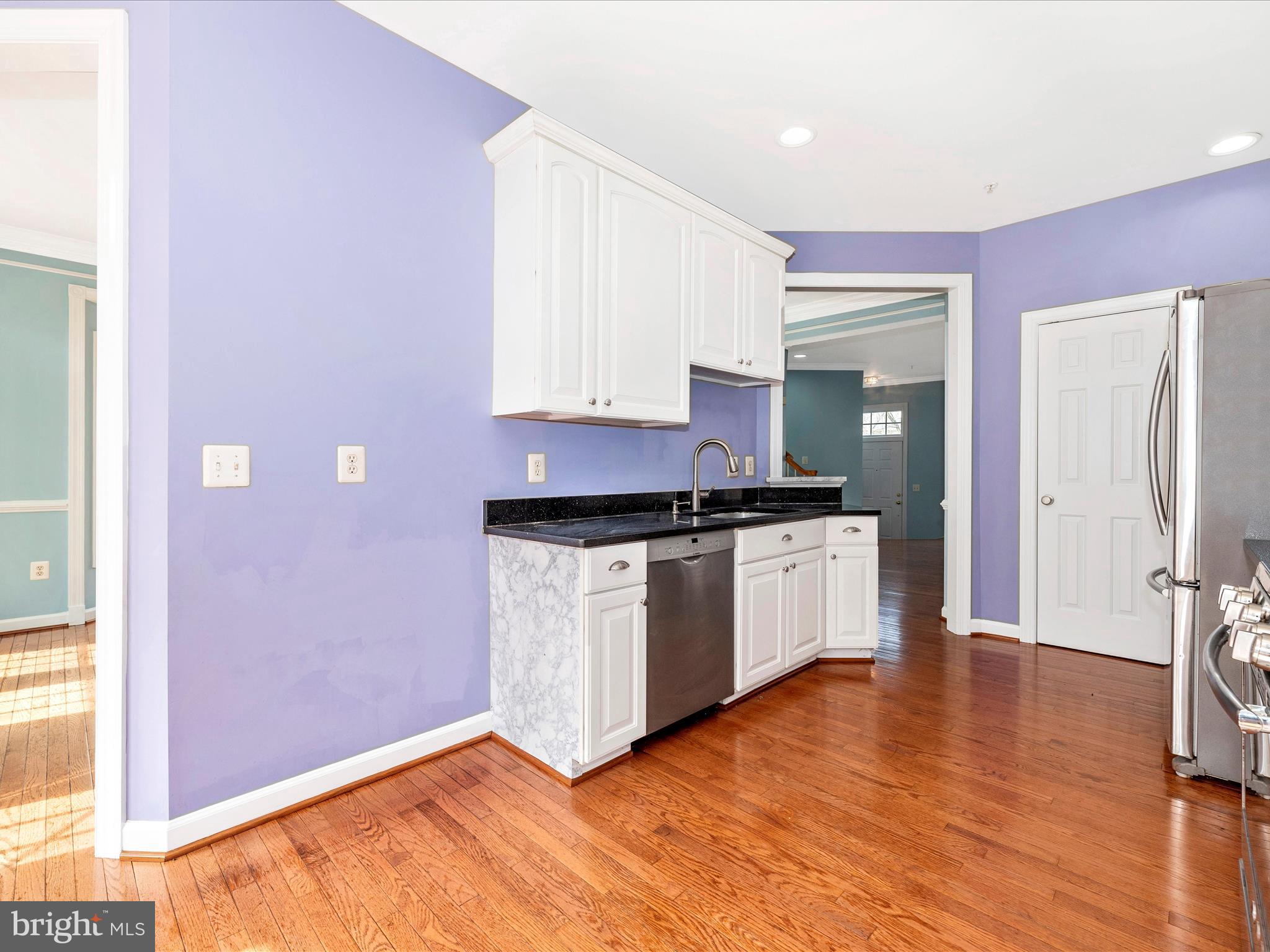10811 Wadsworth Road Woodstock, MD 21163 - Photo 17 of 66 a kitchen with granite countertop white cabinets and white appliances