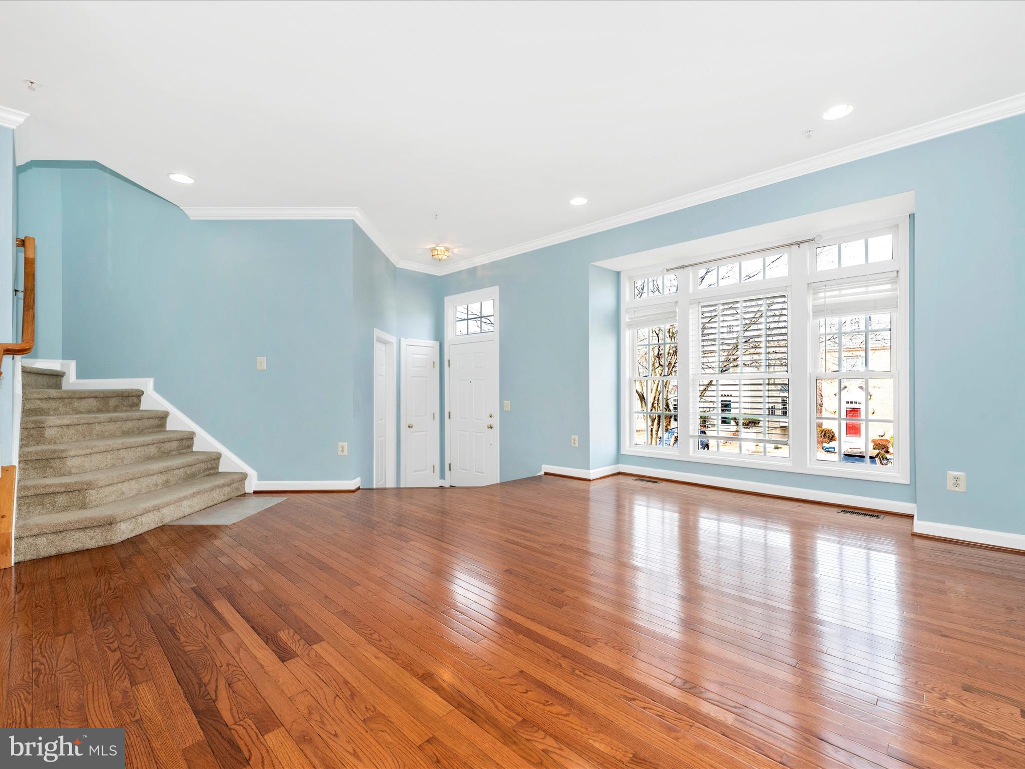 10811 Wadsworth Road Woodstock, MD 21163 - Photo 6 of 66 a view of an empty room with wooden floor and a window