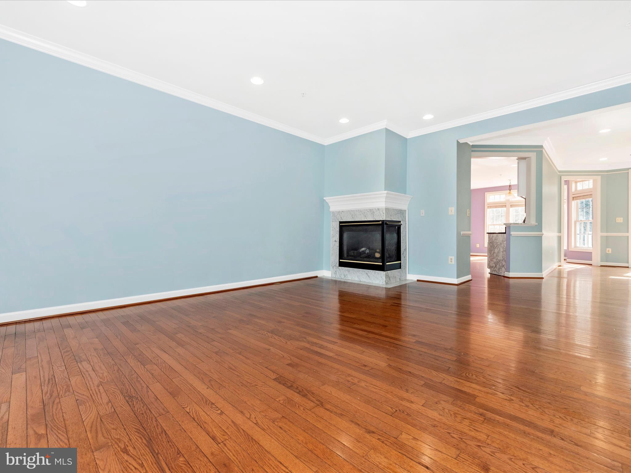 10811 Wadsworth Road Woodstock, MD 21163 - Photo 7 of 66 a view of empty room with wooden floor and fireplace