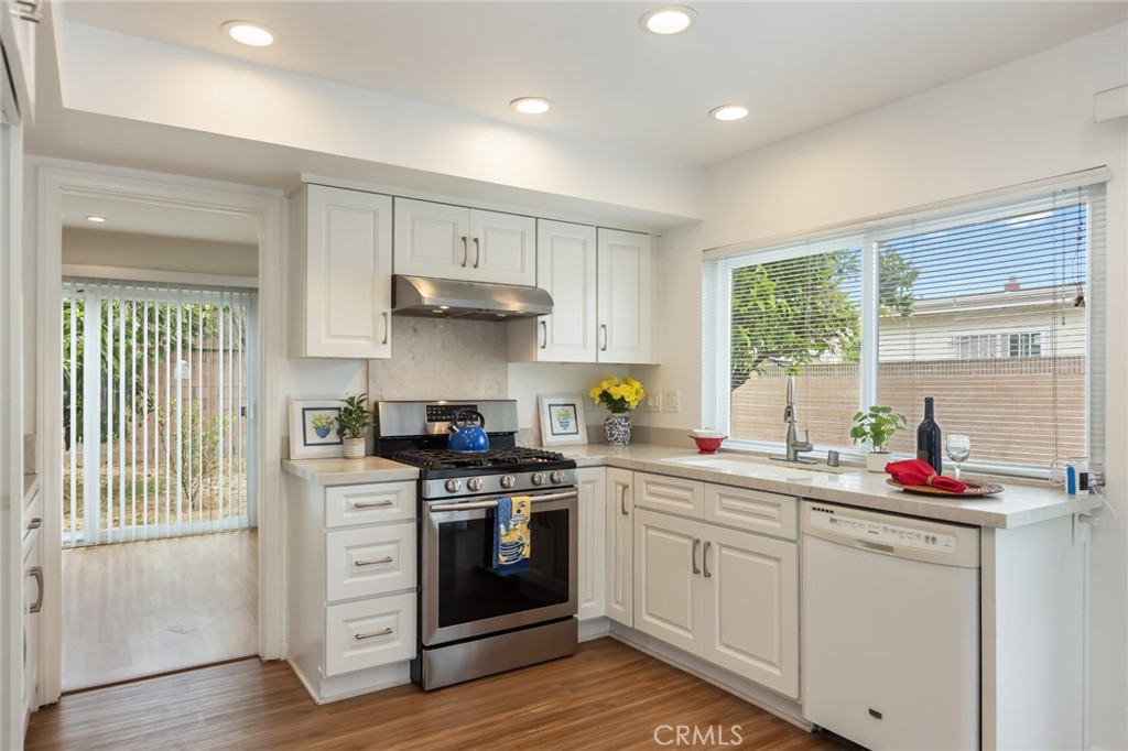 20233 Campaign Drive Carson, CA 90746 - Photo 13 of 44 a kitchen with stainless steel appliances a sink stove and cabinets
