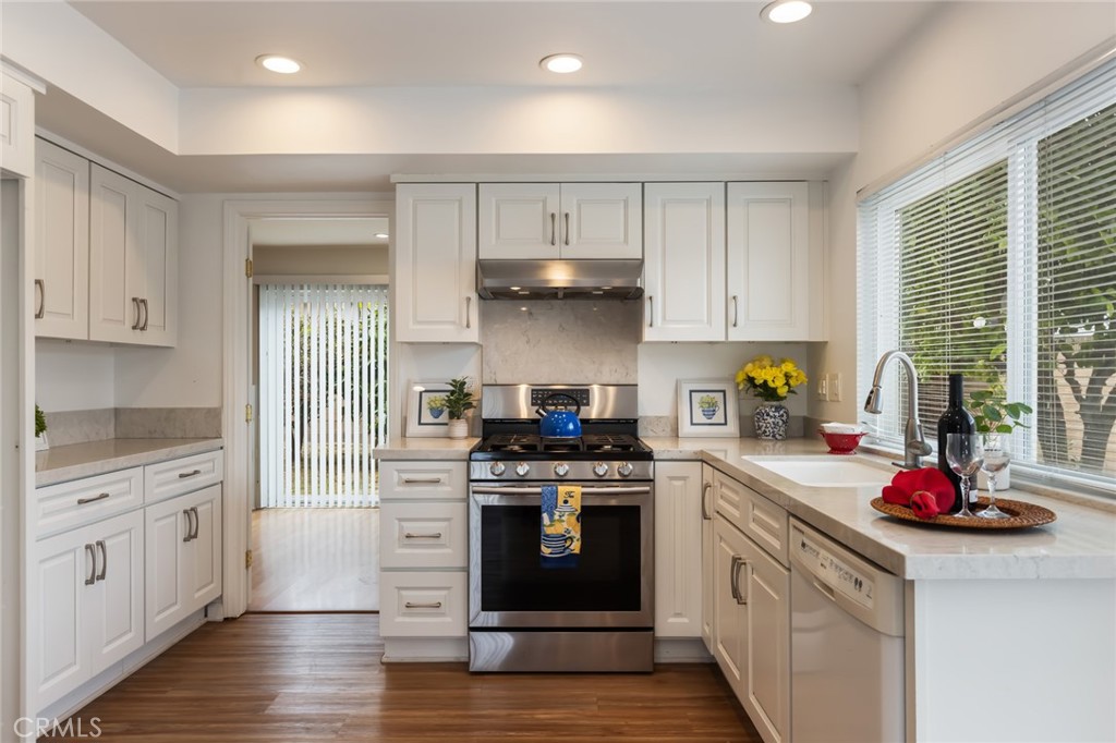 20233 Campaign Drive Carson, CA 90746 - Photo 14 of 44 a kitchen with a stove top oven and cabinets