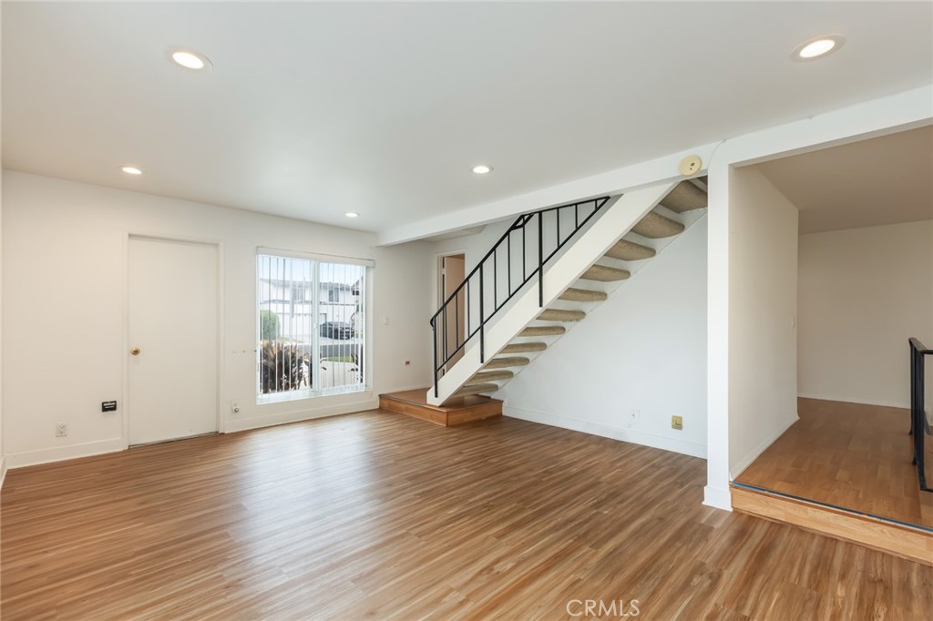 20233 Campaign Drive Carson, CA 90746 - Photo 18 of 44 a view of an empty room with wooden floor and stairs