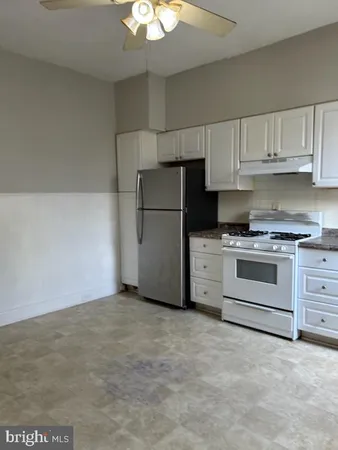 a kitchen with cabinets stainless steel appliances and sink