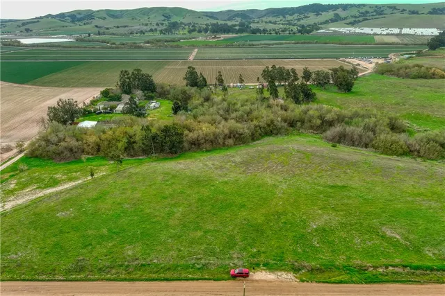 a view of an ocean and a field