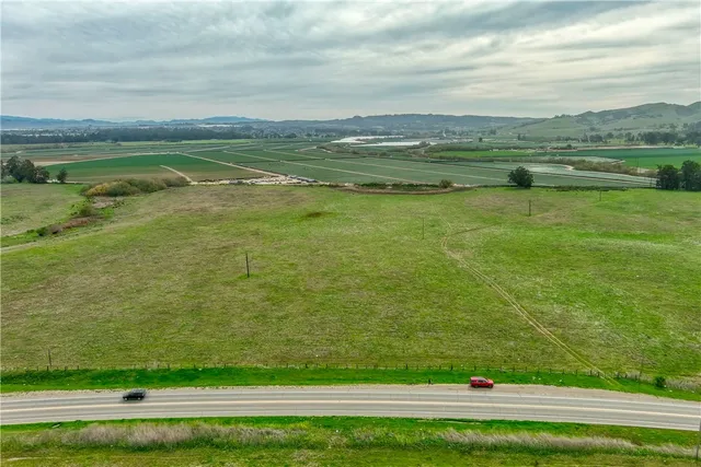 a view of a green field with an ocean